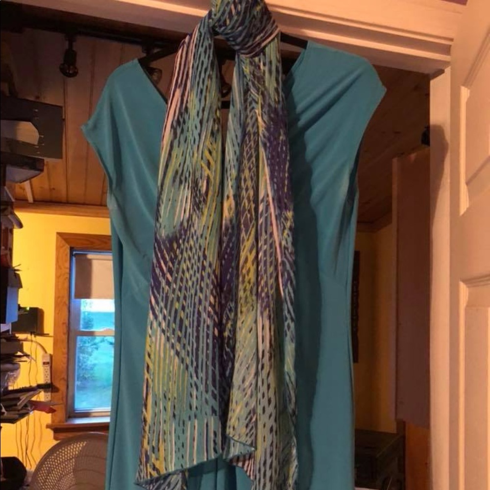 Woman’s teal dress and scarf